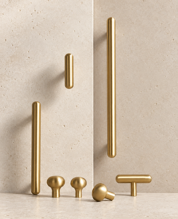 Solid Brass Smooth Round Knob displayed on pale limestone.