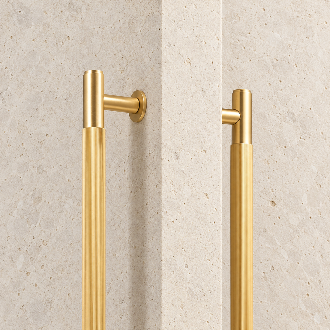 Brass Linear Door Pull Bar displayed on pale limestone.