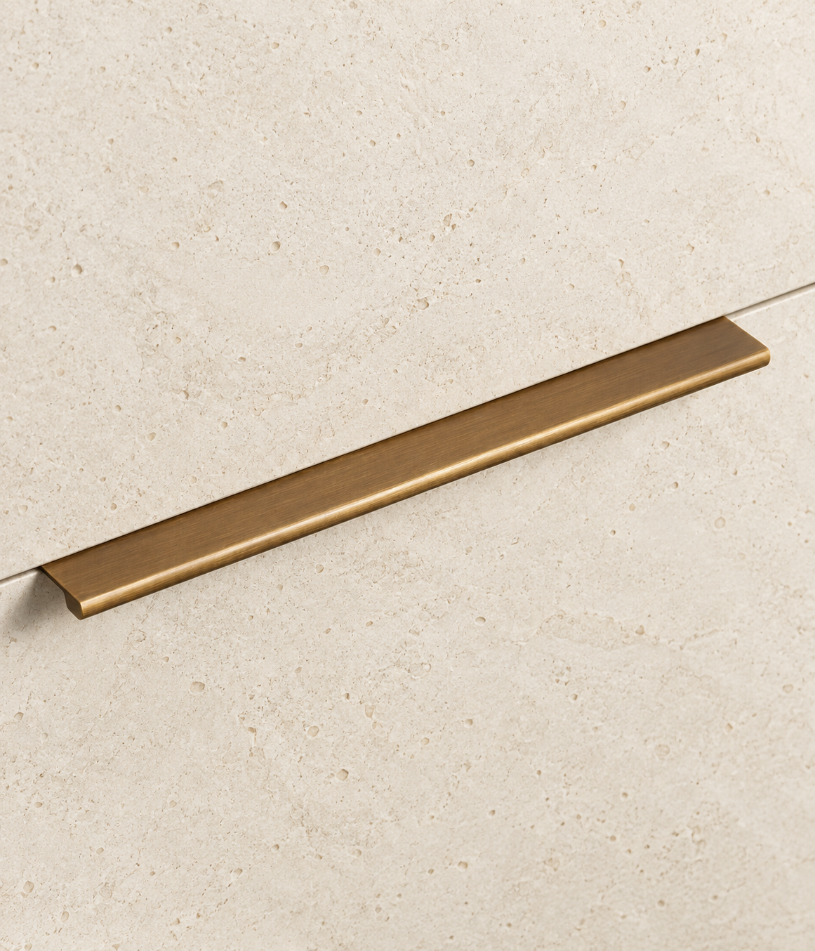 Solid Brass Edge Pull Handle displayed on pale limestone.
