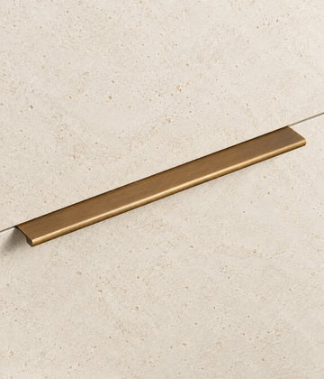 Solid Brass Edge Pull Handle displayed on pale limestone.