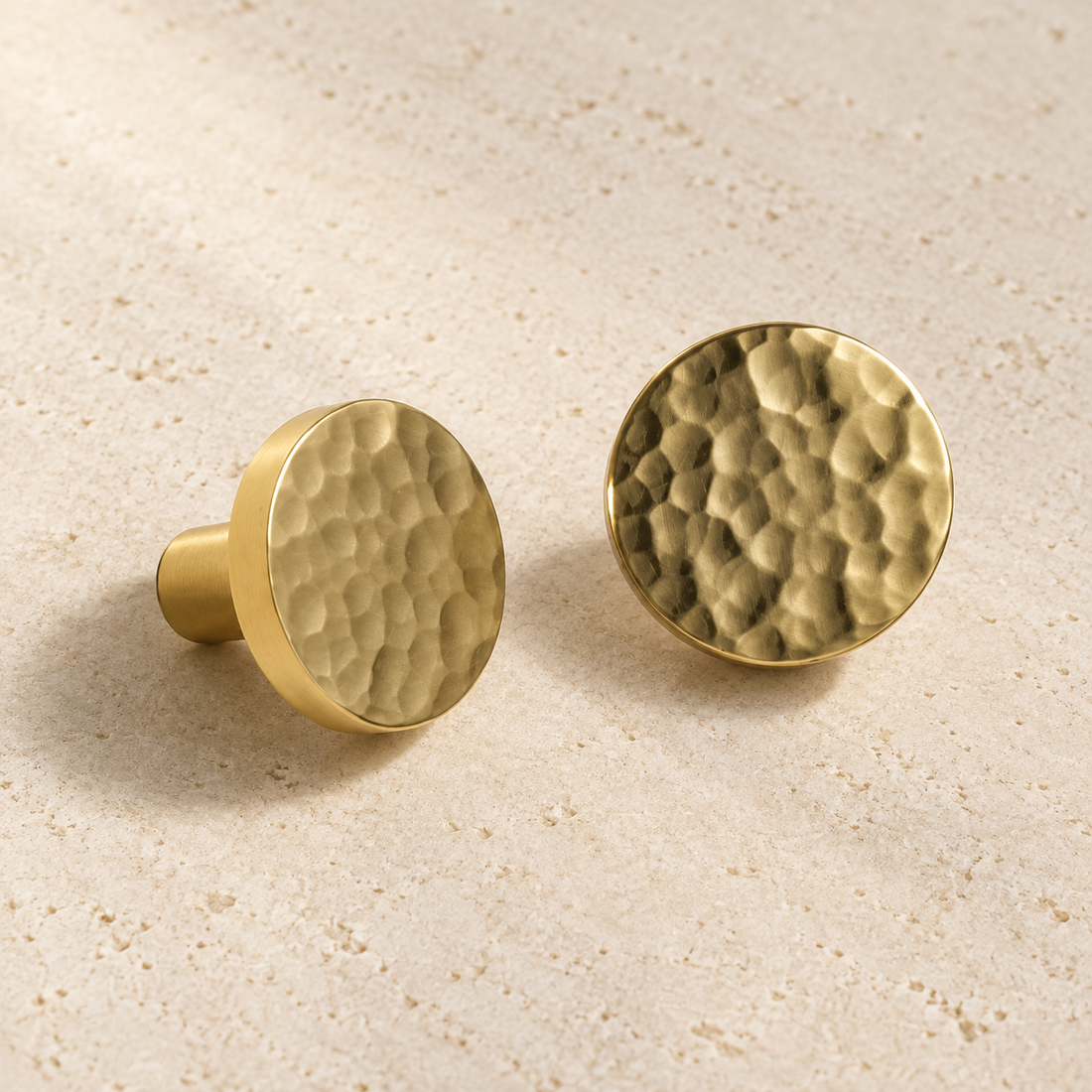 Solid Brass Hammered Cabinet knob Handle displayed on pale limestone.