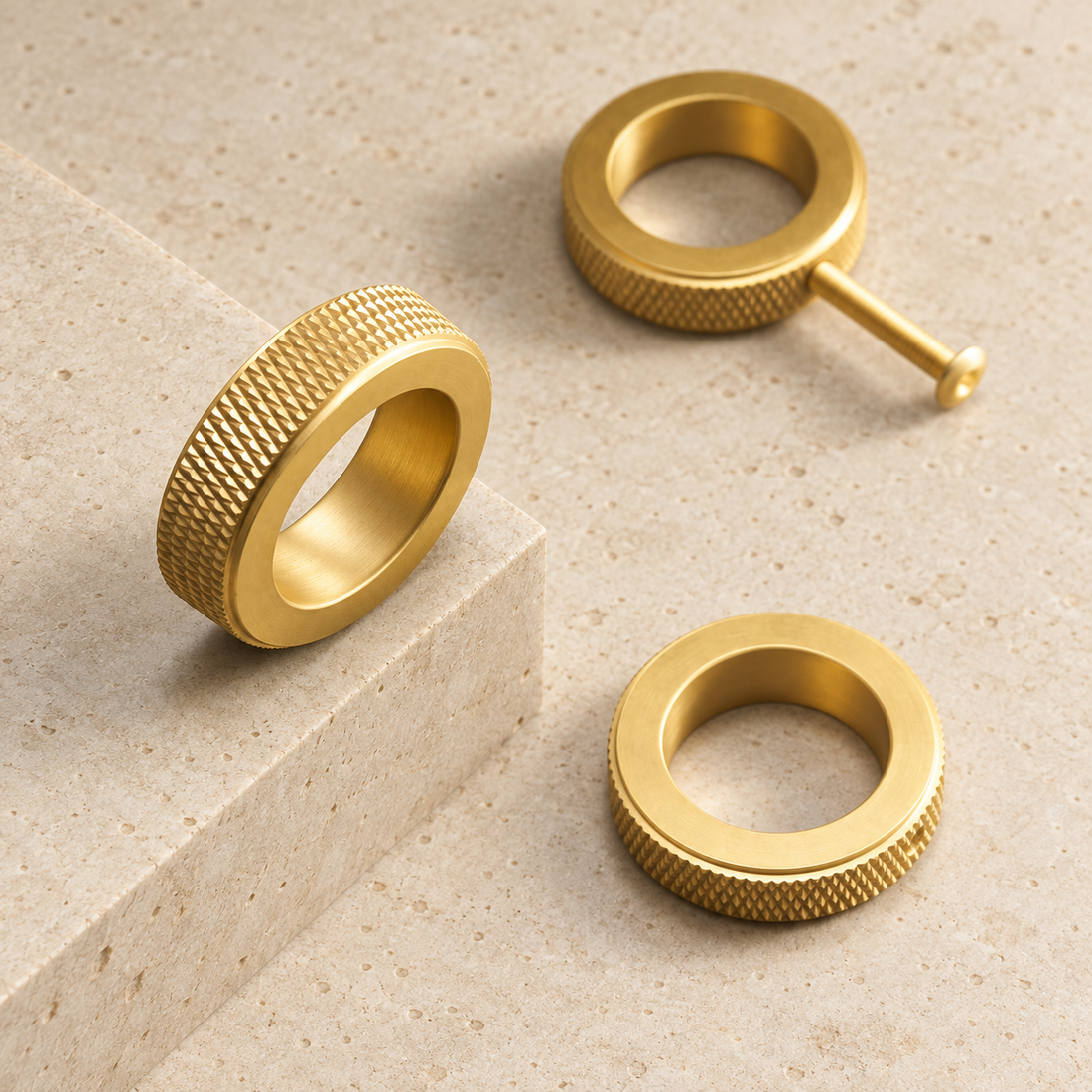 Solid Brass Knurled Ring Cabinet Knob displayed on pale limestone.