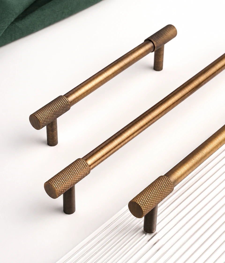 Smooth brass grips and diamond-knurled ends on cabinet bar pulls
