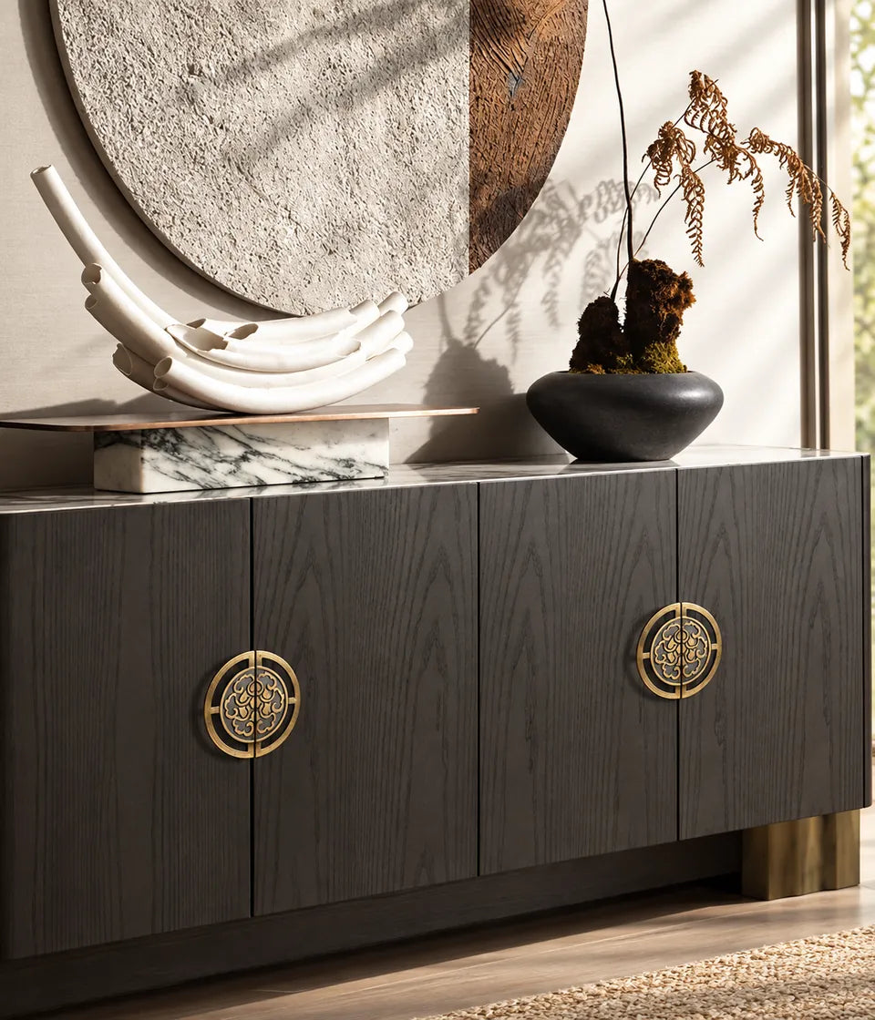 Antique brass scroll medallion pull pairs on a dark wood cabinet