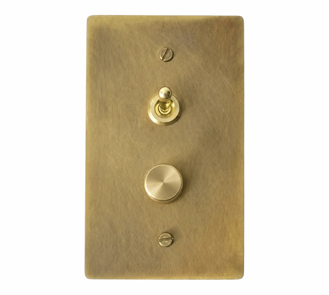 1-gang antique brass (hand-brushed) plate. One smooth brass retro toggle above one 250W single-pole brass rotary dimmer, stacked vertically on a single-gang plate.