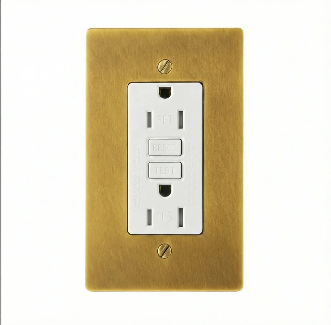 White 15A GFCI outlet in an antique brass hand-brushed single-gang plate with brass screws