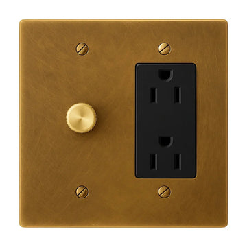 2-gang unlacquered antique brass (hand-brushed) plate. One 250W single-pole brass rotary dimmer on the left and one black regular 15A duplex outlet on the right.