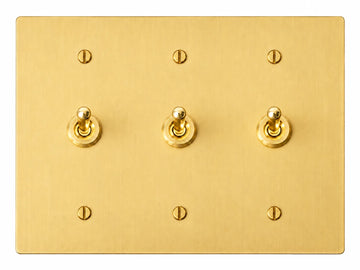 Satin Brass three-gang plate with three smooth retro brass toggle switches and six brass screws