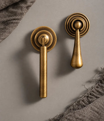 Antique brass cylinder and ringed teardrop cabinet pendant pulls