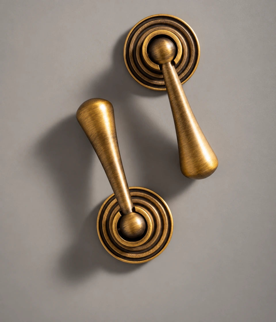 Ringed teardrop brass pendants showing round bases and hinged grips