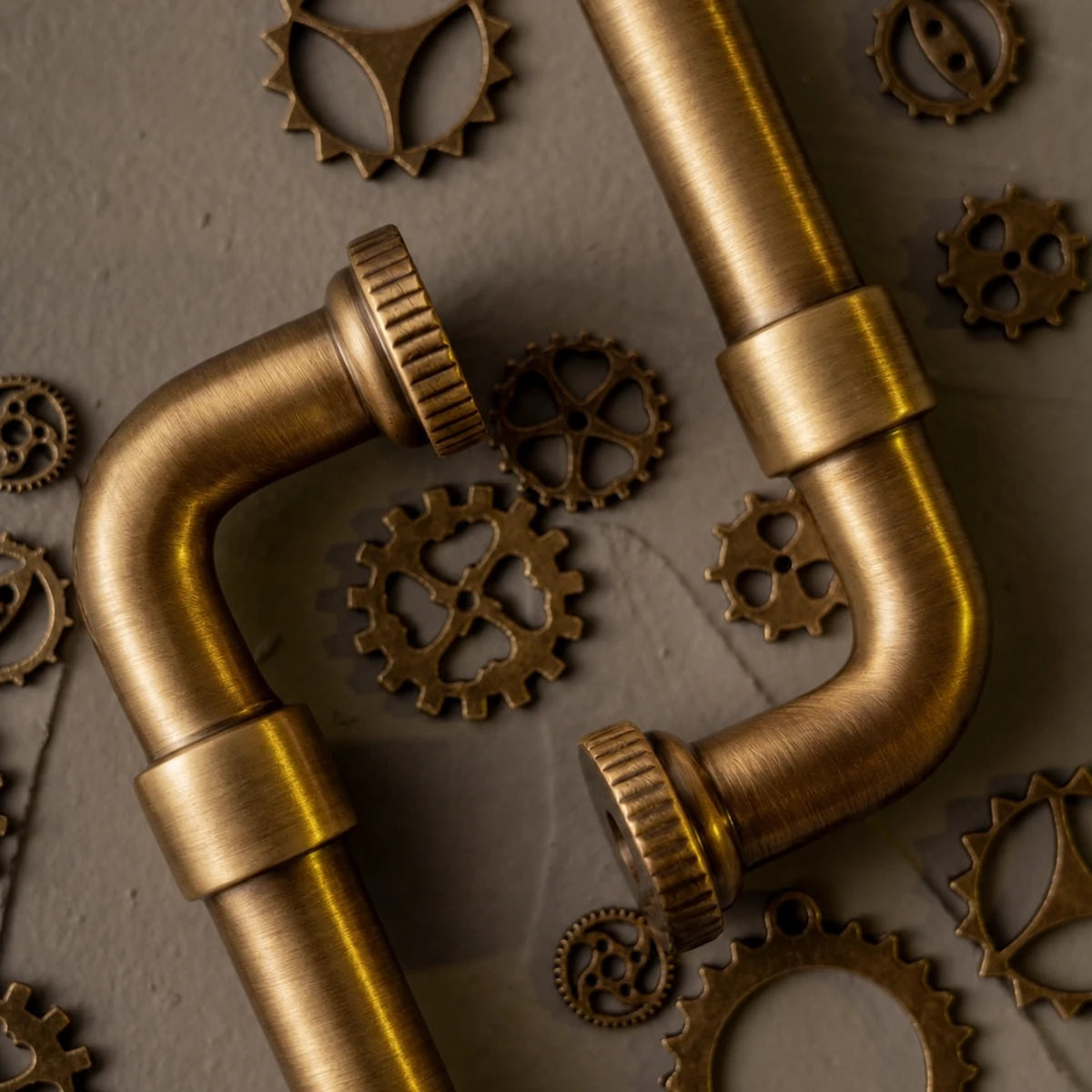 Close-up of brushed brass pipe grip, collars and ridged mounting feet