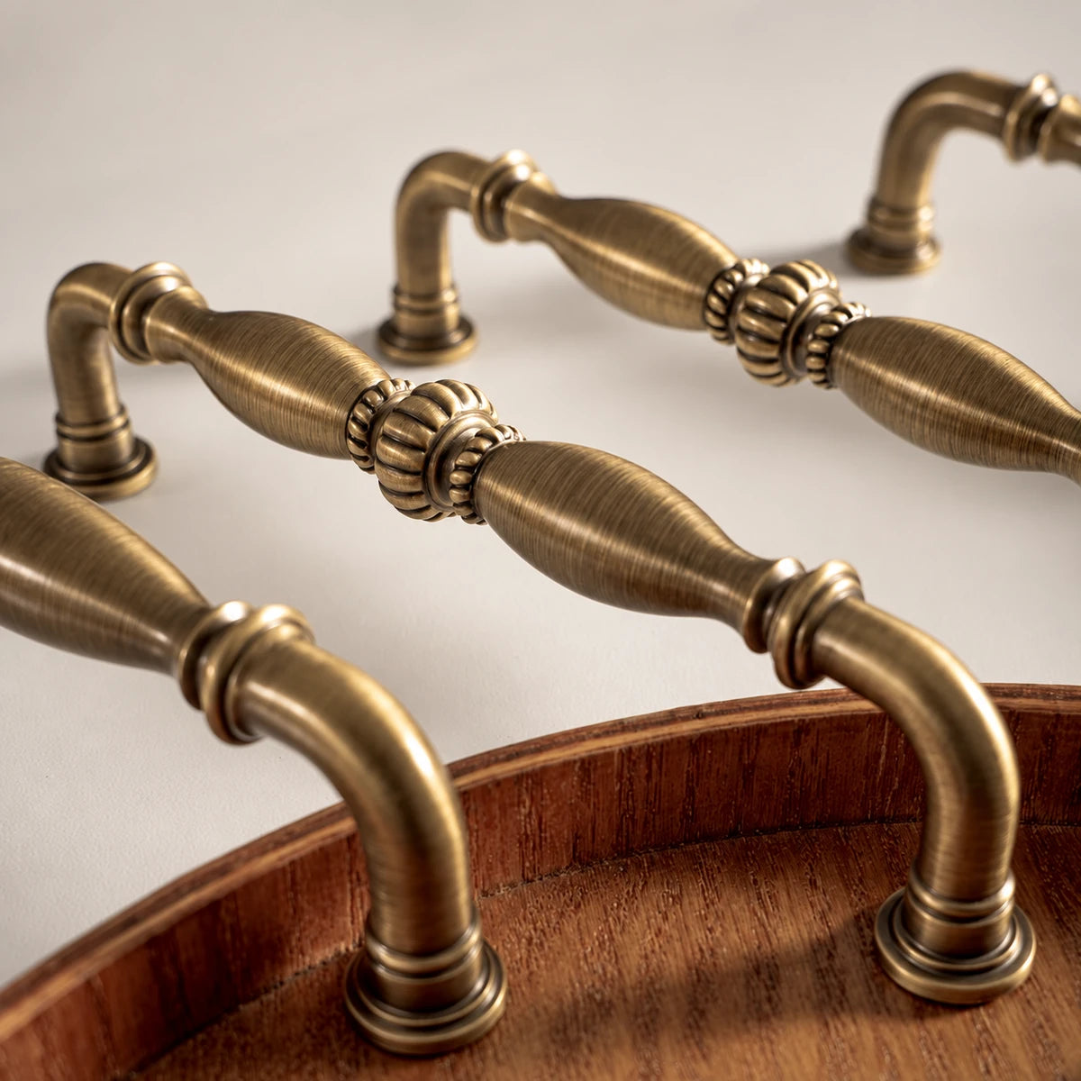 Close-up of ribbed center ornament and tapered antique brass grips