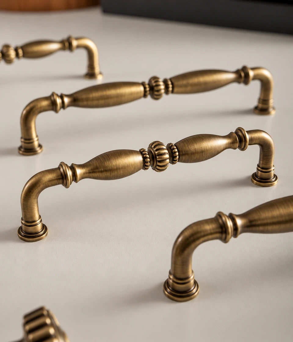 Ribbed center brass cabinet pulls arranged on a tabletop