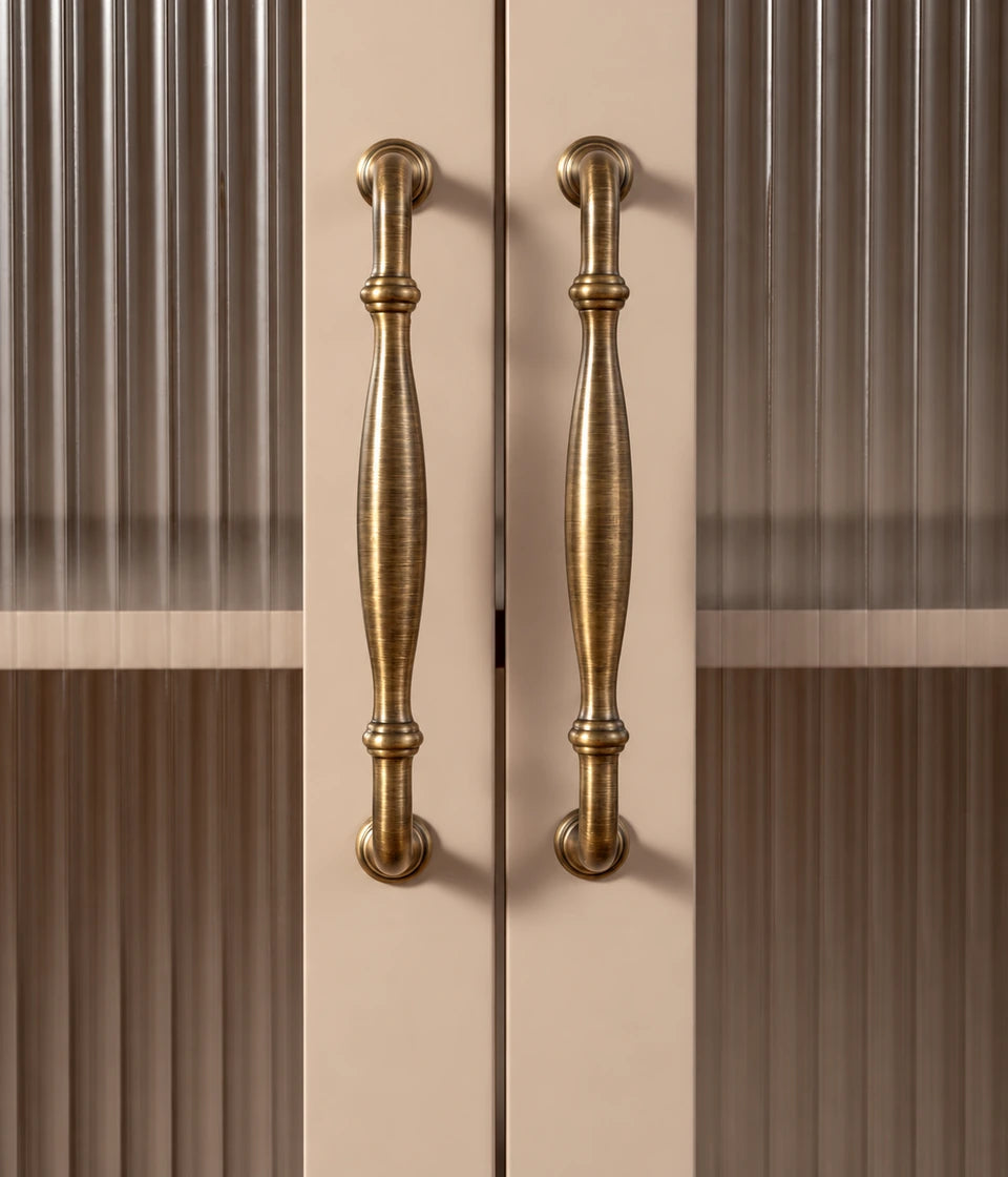 Antique brass ringed bow pulls on fluted glass cabinet doors