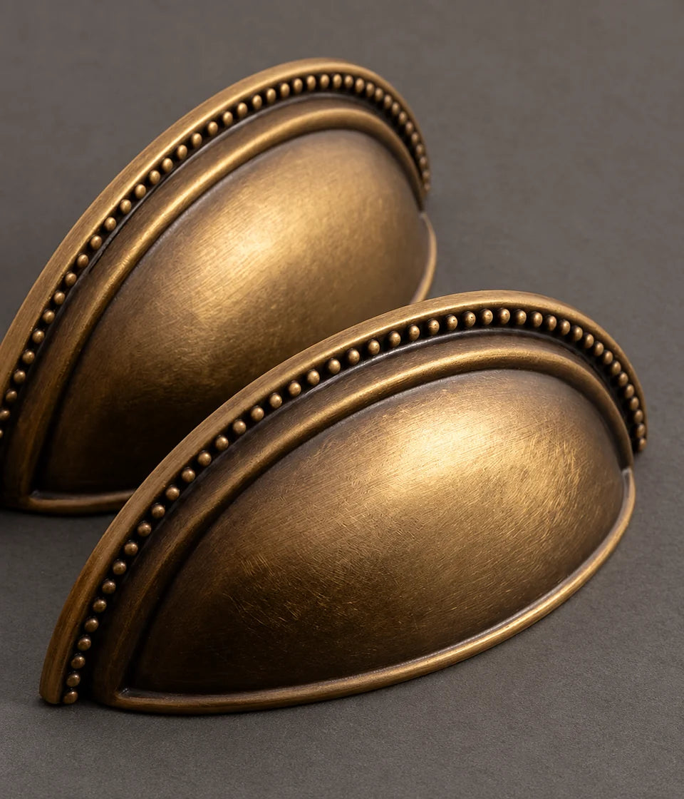 Close-up of deep semicircular cup pulls with raised beaded rims