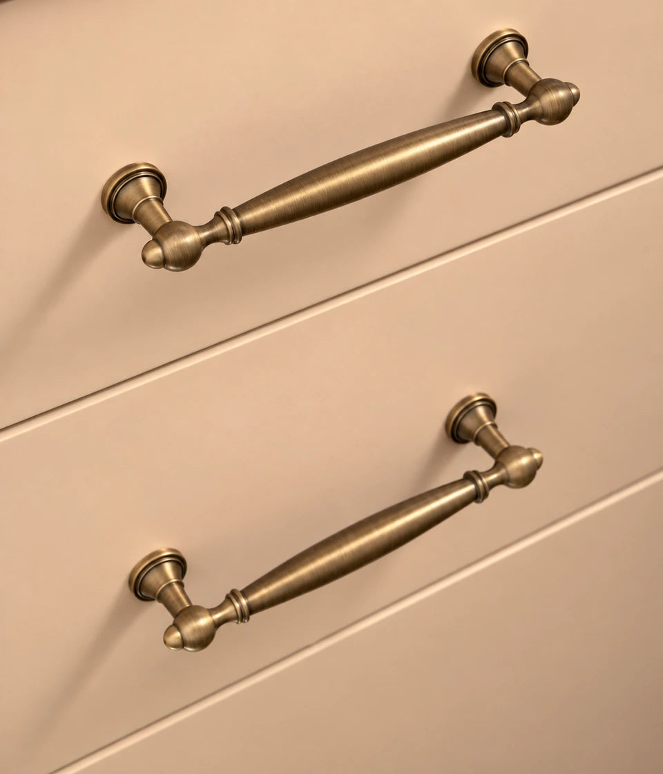 Two smooth spindle pulls with rounded finial posts on drawers
