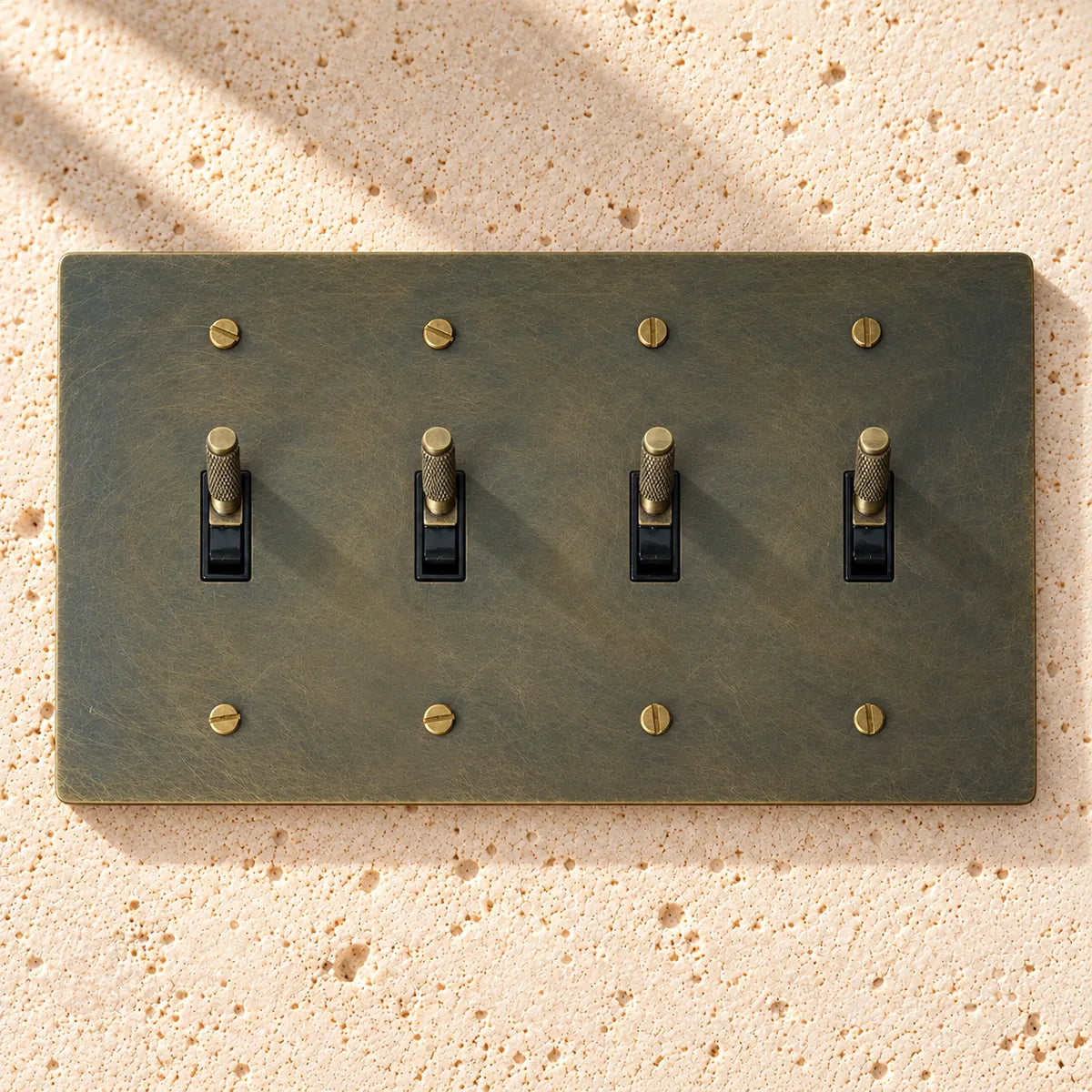 4-gang knurled toggle light switch plate in aged bronze, hand-brushed, front view