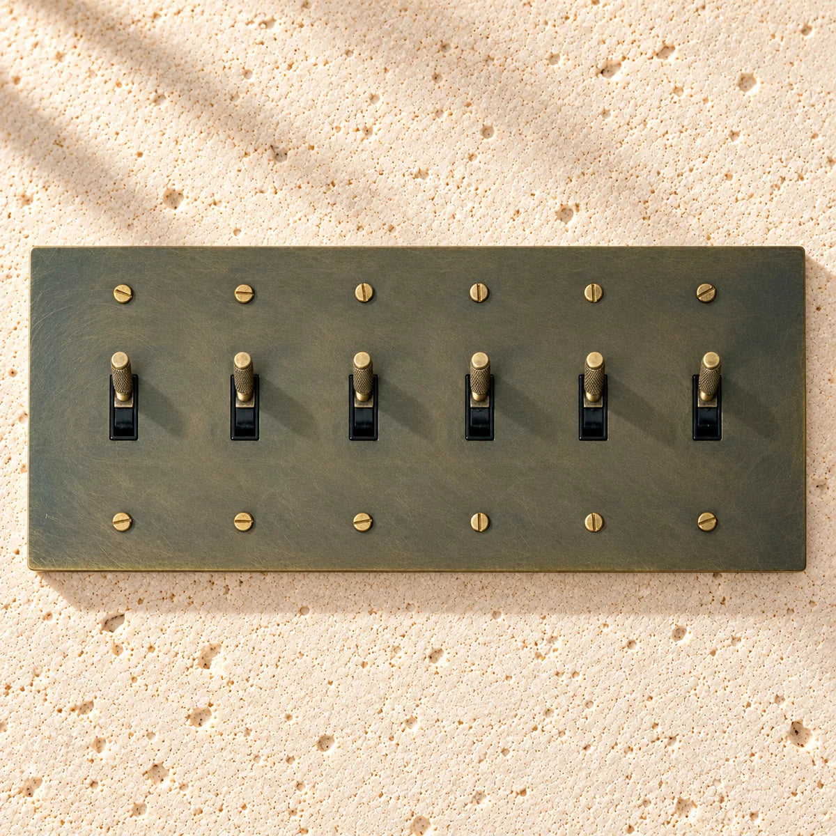 6-gang knurled toggle light switch plate in aged bronze, hand-brushed, front view