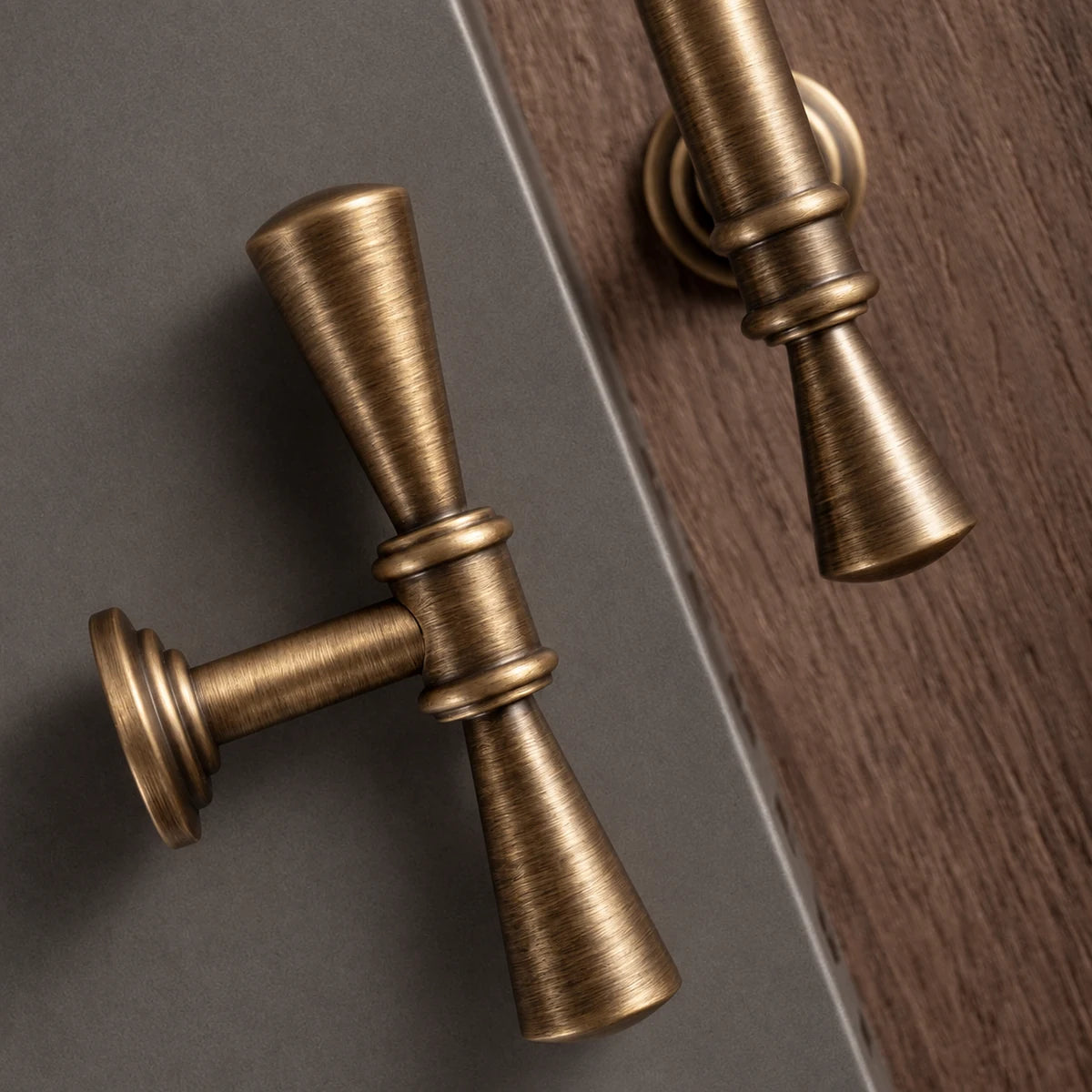 Close-up of flared trumpet tips and raised rings on antique brass cabinet pulls
