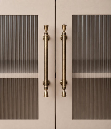Antique brass trumpet tip cabinet pulls installed on fluted glass doors