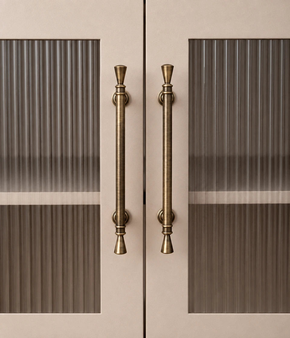Antique brass trumpet tip cabinet pulls installed on fluted glass doors