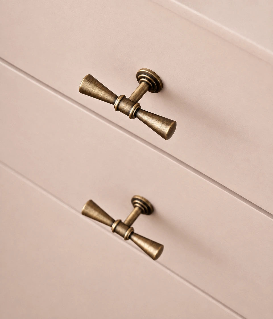 Antique brass trumpet tip T-knobs installed on cabinet fronts