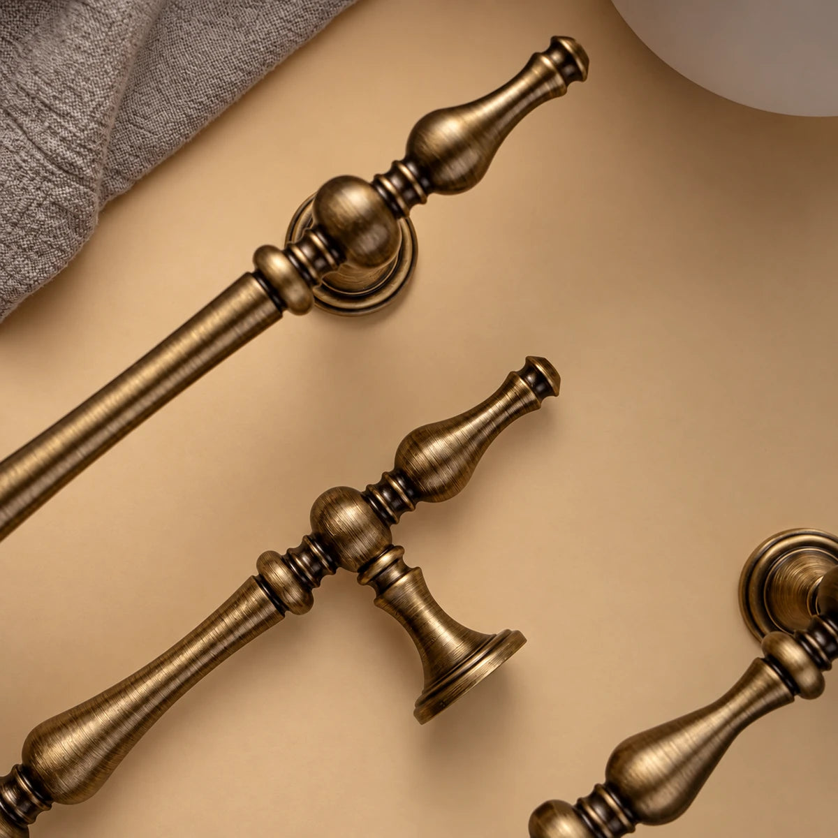 Close-up of antique brass spindle pull finials and mounting posts