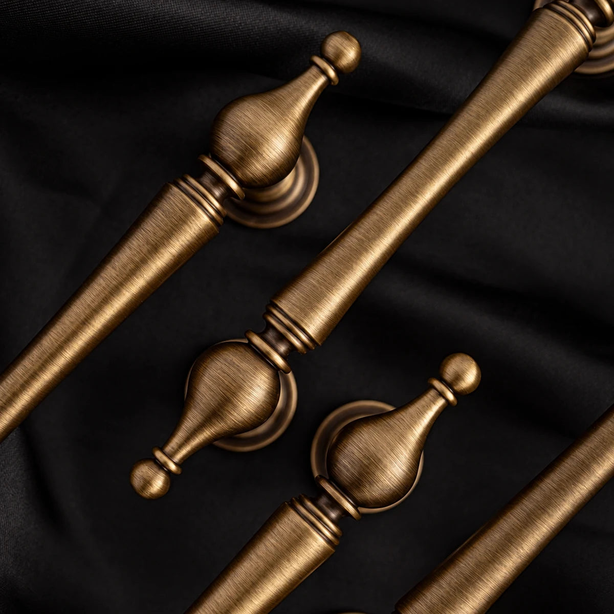 Turned urn-shaped finials and gently waisted antique brass grips