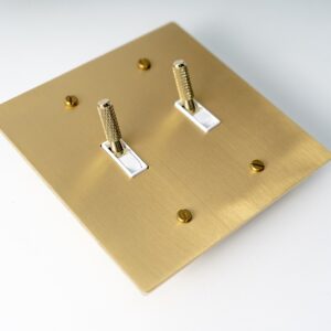 Satin Gold Knurled Two-Gang Toggle Switch - Textured dual switch panel with a stylish gold finish