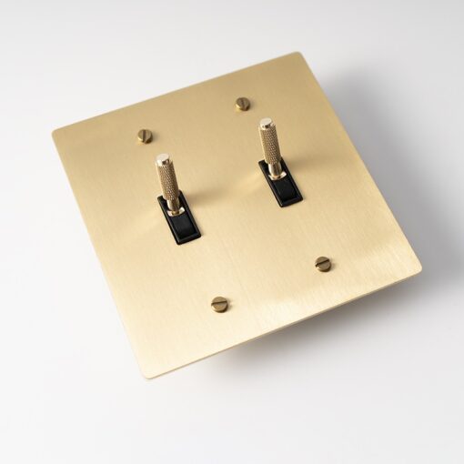 Two-Gang Satin Gold Brass Toggle Switch - Elegant dual-toggle switch in a durable satin gold brass finish