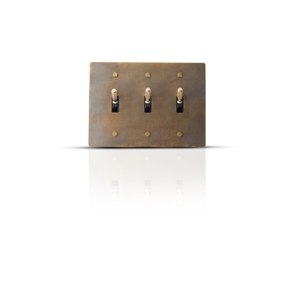 Antique finish brass toggle switch plate with three gangs for classic interior control.