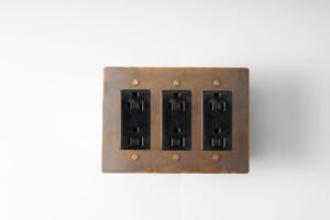 aged brass 3-gang duplex power outlet, a vintage-inspired electrical solution for comprehensive utility in your space