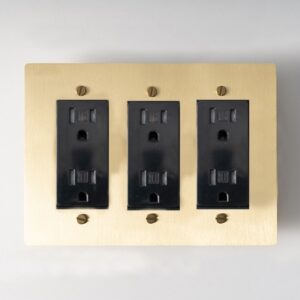 triple-gang golden brass panel, an elegant and versatile electrical solution for contemporary spaces