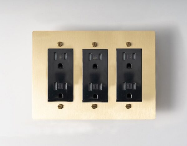 triple-gang golden brass panel, an elegant and versatile electrical solution for contemporary spaces