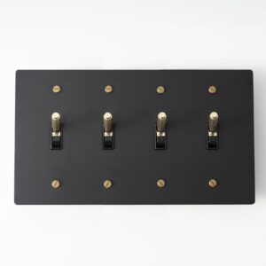 Four-Gang Black Brass Plate with Golden Knurled Toggle Switch - Sleek quadruple-toggle switch in a black brass finish, accentuated by golden knurled detailing for a sophisticated touch