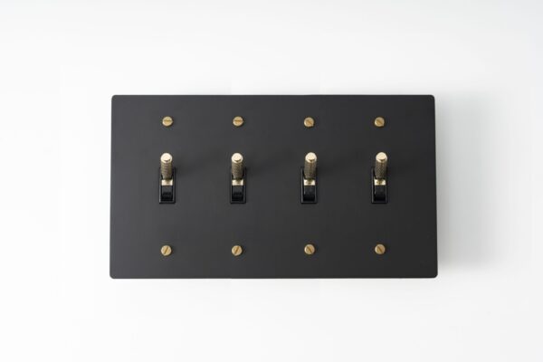 Four-Gang Black Brass Plate with Golden Knurled Toggle Switch - Sleek quadruple-toggle switch in a black brass finish, accentuated by golden knurled detailing for a sophisticated touch