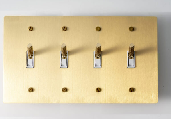 satin gold solid brass 4 gang panel featuring knurled toggle switches