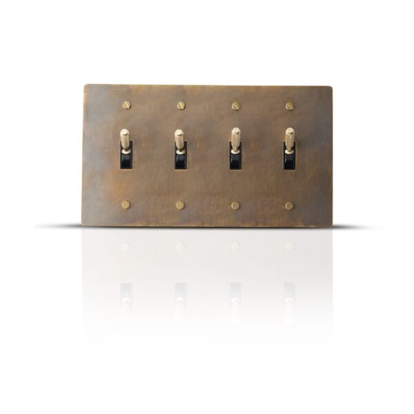 Antique finish brass toggle switch plate with four gangs for classic interior control.