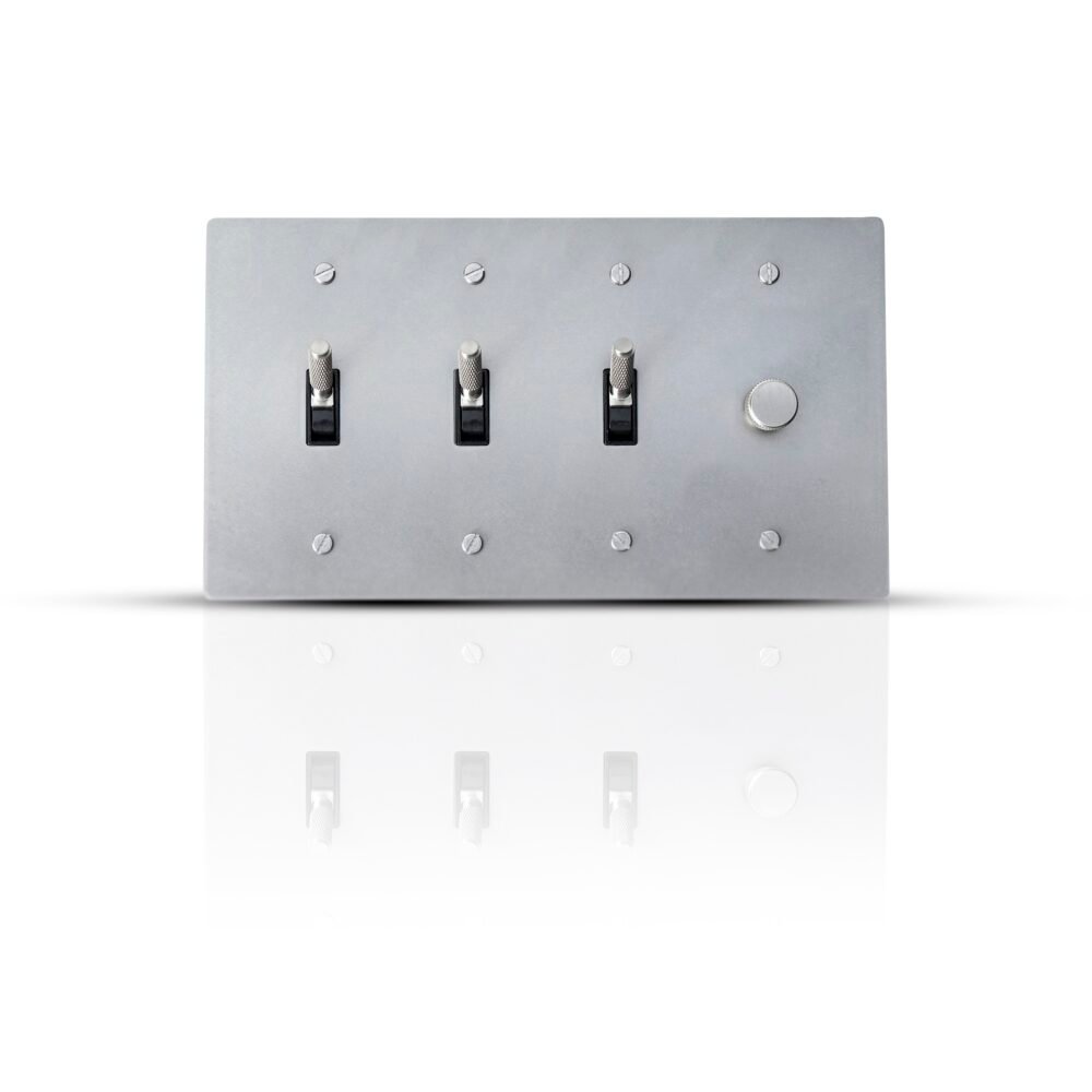 A sophisticated brass combo plate featuring three toggle switches and one dimmer control, elegantly designed for versatile lighting management in stylish interiors.